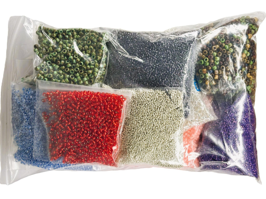 Assorted colored beads in a clear plastic bag on a white background